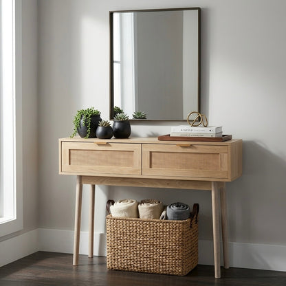 Wooden console table with a mirror, plants, and books in a room.