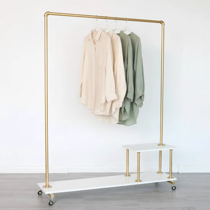 Gold clothing rack with white board in a room with framed pictures on the wall