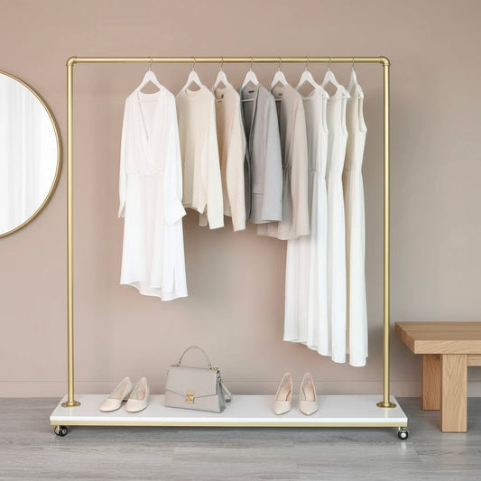 Gold clothing rack with white and gray garments, a handbag, and shoes on a neutral background.