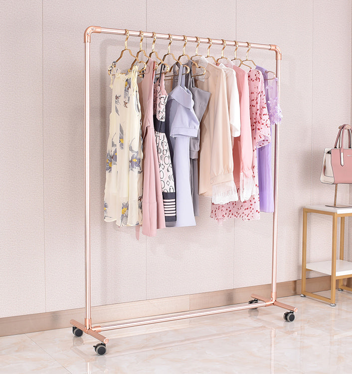 Clothing rack with clothes on wheels in a room setting